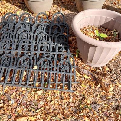9 black connecting plastic fence pieces with a large flowerpot