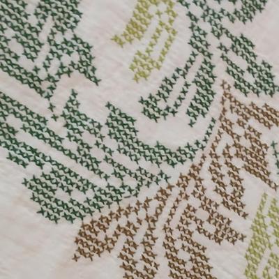 Embroidered floral quilt with soft blue blanket