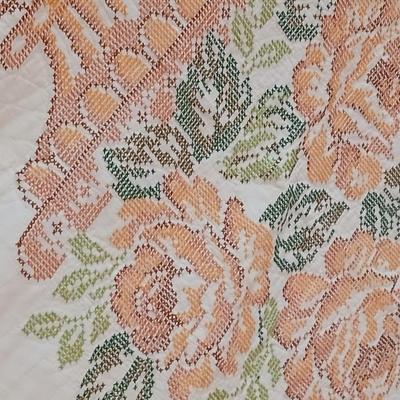 Embroidered floral quilt with soft blue blanket