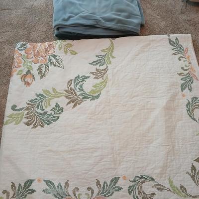 Embroidered floral quilt with soft blue blanket