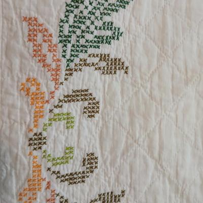 Embroidered floral quilt with soft blue blanket