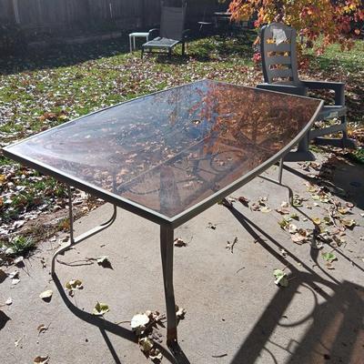 SMOKEY GLASS TOP PATIO TABLE AND TWO BIG EASY ROCKING CHAIRS