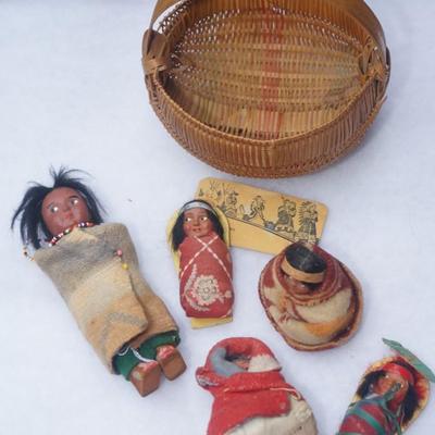 GROUPING OF FIVE SMALLER SIZE SKOOKUM DOLLS OF CHILDREN & HAND WOVEN SPLINT BASKET OF 8"