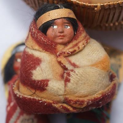 GROUPING OF FIVE SMALLER SIZE SKOOKUM DOLLS OF CHILDREN & HAND WOVEN SPLINT BASKET OF 8"