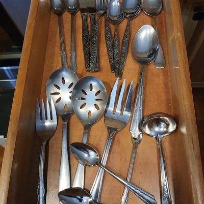Assortment of flatware that doesn't all match - forks - spoons - butter knives - serving utensils 50 +