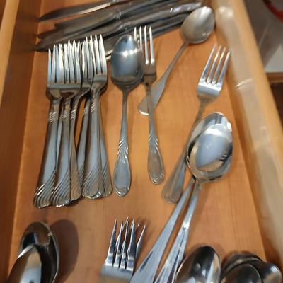Assortment of flatware that doesn't all match - forks - spoons - butter knives - serving utensils 50 +