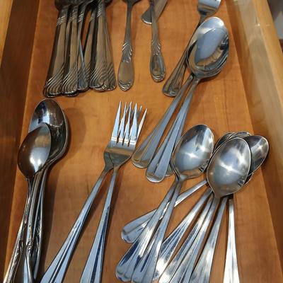 Assortment of flatware that doesn't all match - forks - spoons - butter knives - serving utensils 50 +