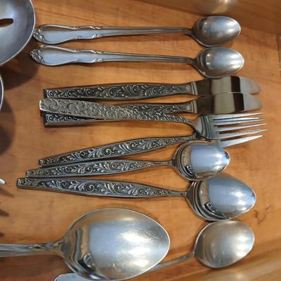 Assortment of flatware that doesn't all match - forks - spoons - butter knives - serving utensils 50 +