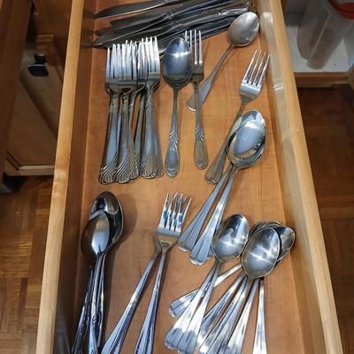 Assortment of flatware that doesn't all match - forks - spoons - butter knives - serving utensils 50 +