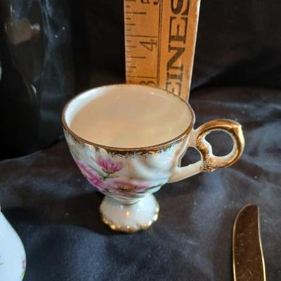 Two dainty teacups with salt & pepper and gold toned Americana Golden Heritage flatware