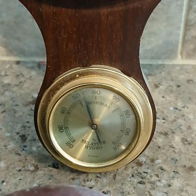 Two wooden base candle holders with globes and a thermometer barometer to hang on your wall