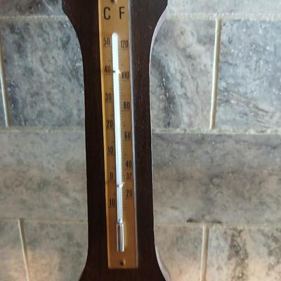 Two wooden base candle holders with globes and a thermometer barometer to hang on your wall
