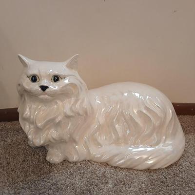 Large ceramic cat with a metal plant stand