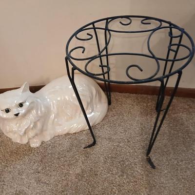 Large ceramic cat with a metal plant stand