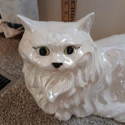 Large ceramic cat with a metal plant stand