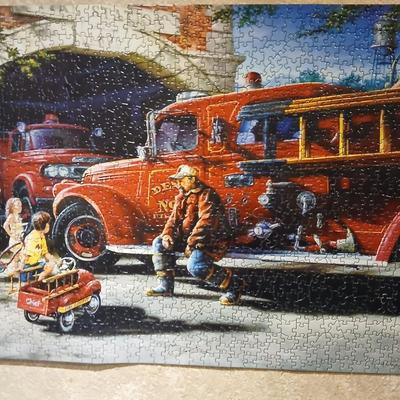 Completed Fireman puzzle with Dalmation salt & pepper shakers with a wooden shelf and picture frame