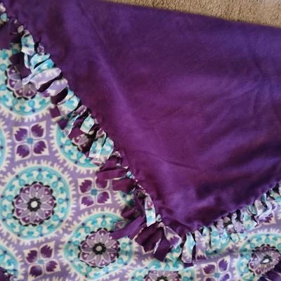 Two throw pillows and a homemade knotted blanket