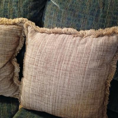 Two throw pillows and a homemade knotted blanket