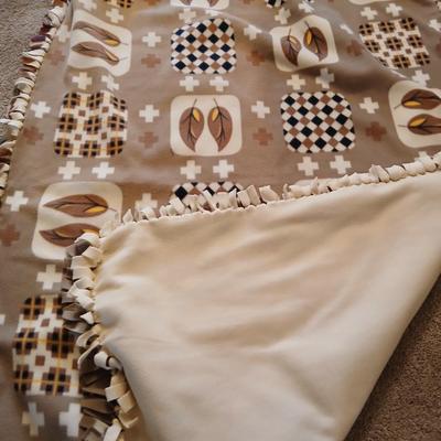 Two throw pillows and a homemade knotted blanket