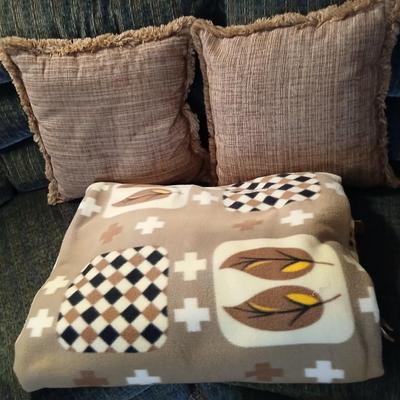 Two throw pillows and a homemade knotted blanket
