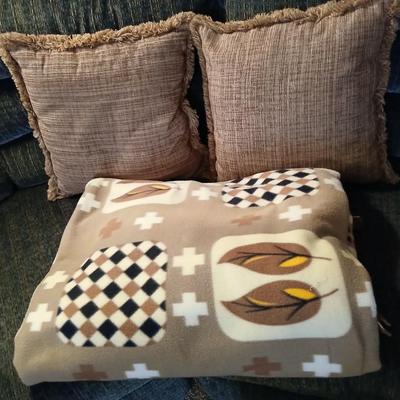 Two throw pillows and a homemade knotted blanket