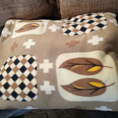 Two throw pillows and a homemade knotted blanket