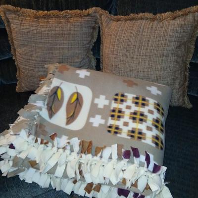 Two throw pillows and a homemade knotted blanket