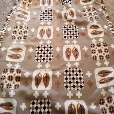 Two throw pillows and a homemade knotted blanket