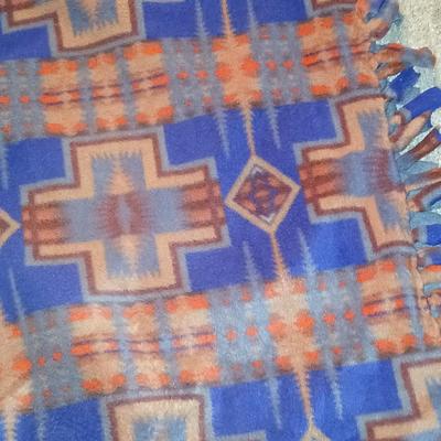 Homemade knotted blanket and a straw hat