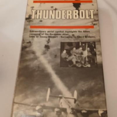 Military plane figure with old calendar of military planes and three VHS tapes
