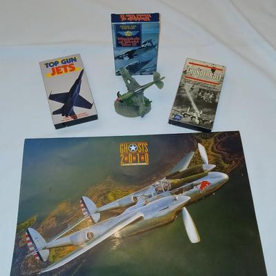 Military plane figure with old calendar of military planes and three VHS tapes