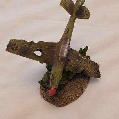 Military plane figure with old calendar of military planes and three VHS tapes