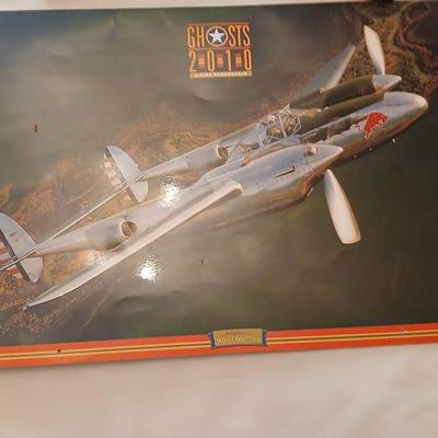 Military plane figure with old calendar of military planes and three VHS tapes