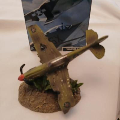 Military plane figure with old calendar of military planes and three VHS tapes