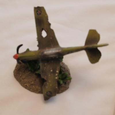 Military plane figure with old calendar of military planes and three VHS tapes