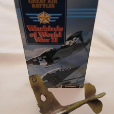 Military plane figure with old calendar of military planes and three VHS tapes
