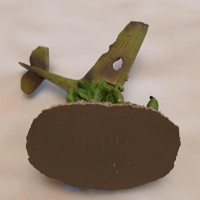 Military plane figure with old calendar of military planes and three VHS tapes