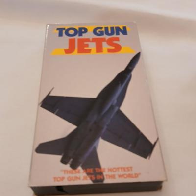 Military plane figure with old calendar of military planes and three VHS tapes