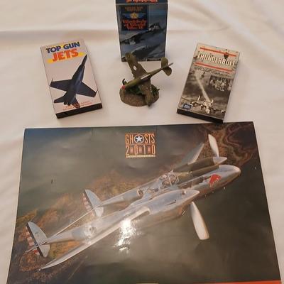 Military plane figure with old calendar of military planes and three VHS tapes
