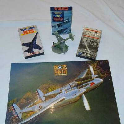 Military plane figure with old calendar of military planes and three VHS tapes