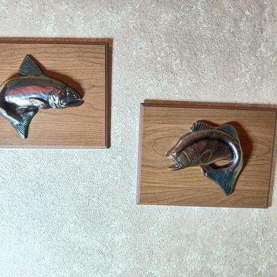 Two brass fish on wood wall art