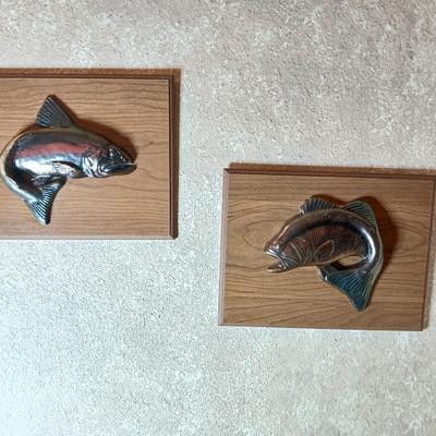 Two brass fish on wood wall art