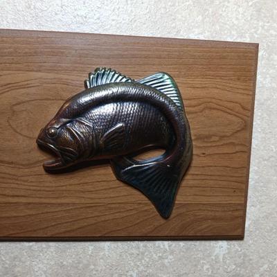 Two brass fish on wood wall art