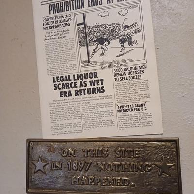 Brass Plaque that reads "On this site in 1897 nothing happened with a Chicago Herald Prohibition ends faux paper