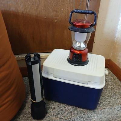 Nice sleeping bag with Stanley tri-pod flashlight and a small cooler