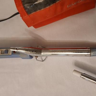 Two curling Irons, make-up travel bags and a set of electric curlers