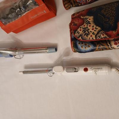 Two curling Irons, make-up travel bags and a set of electric curlers