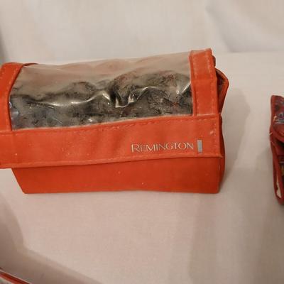 Two curling Irons, make-up travel bags and a set of electric curlers