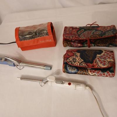 Two curling Irons, make-up travel bags and a set of electric curlers