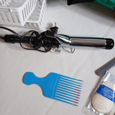 Curling iron, with hair and makeup accessories and a duffle bag with net ends for traveling or leisure